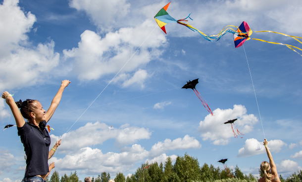people flying kites blue sky