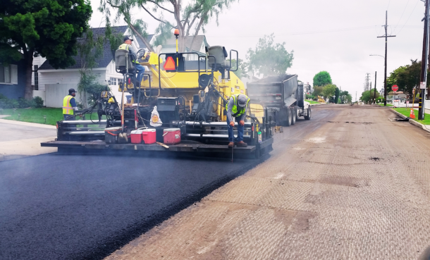 Construction workers on paver on El Segundo Blvd.