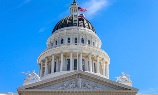 Dome of Sacramento State Capitol with American and California State flags
