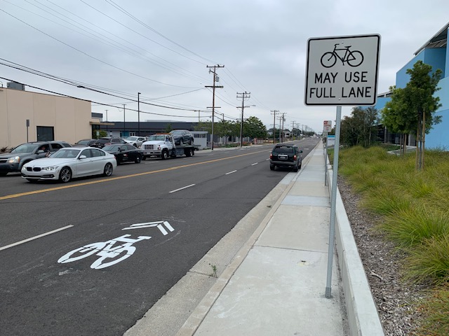 New bikeway sign and pavement marking